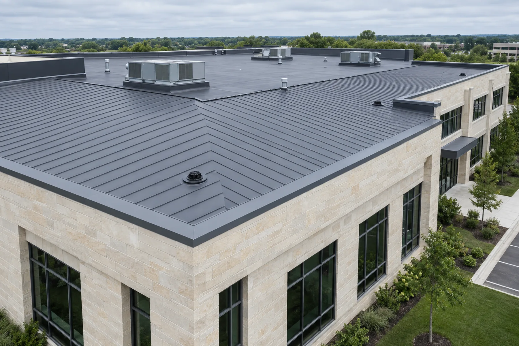 Low-slope commercial roof system on a modern office building with mechanical curbs and clean flashing details